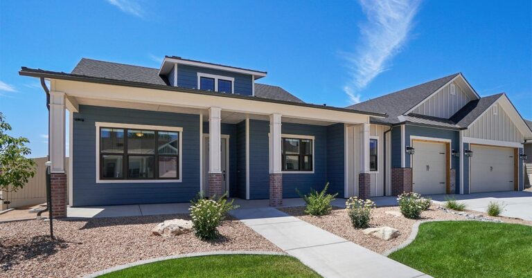 blue gray house with lawn and gravel landscaping gettyimages 1303750117 1200w 628h