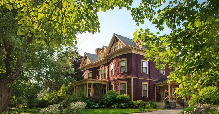 large brick house landscaped yard big trees front and side porches gettyimages 919900950 1200w 628h