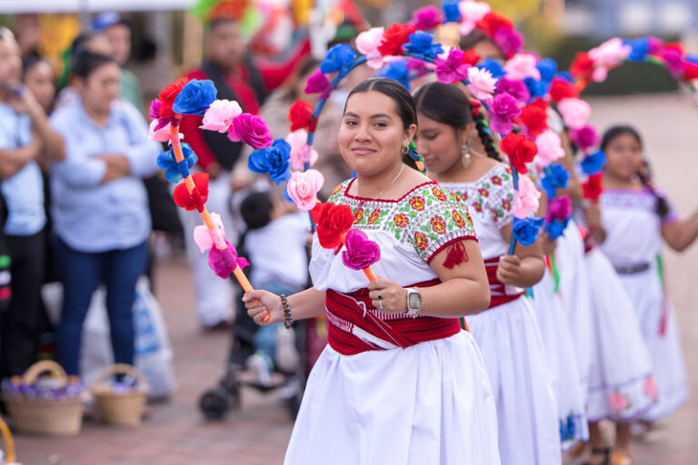 young dancers in traditional costumes performing before the attendees